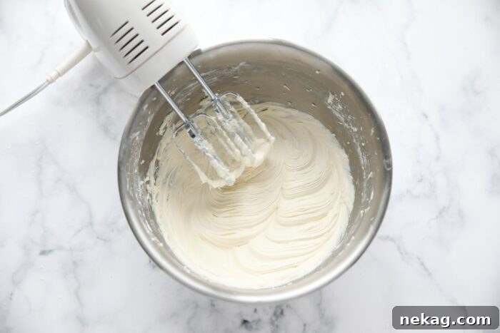 Decadent Red Velvet Brownie Recipe with Cream Cheese Swirl 8 The best cream cheese frosting recipe made in a bowl with an electric hand mixer.