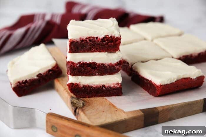Decadent Red Velvet Brownie Recipe with Cream Cheese Swirl 10 Stack of three Red Velvet Brownies with cream cheese frosting.