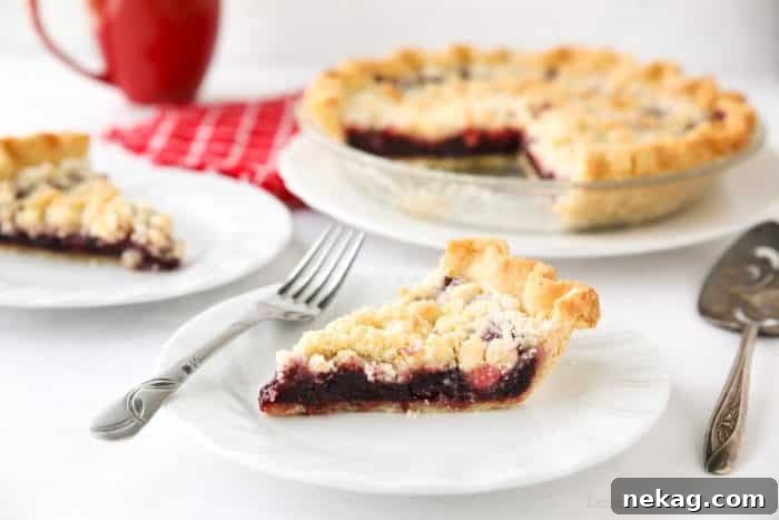 Cherry Crumb Pie can be made with fresh or frozen cherries, flavored with a hint of almond extract, and topped with a sweet crumble topping. Easy and delicious!