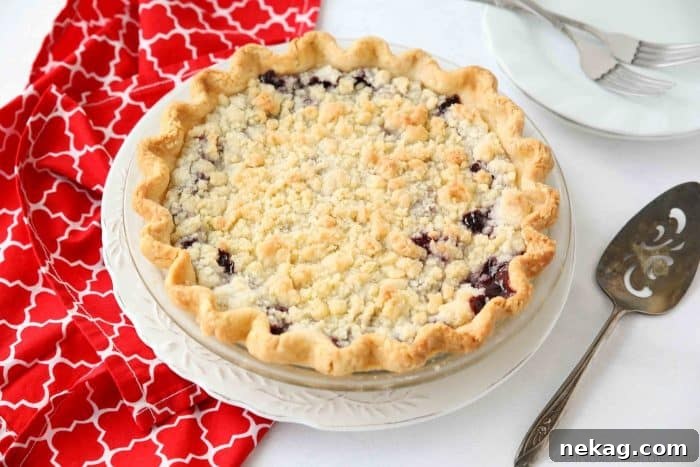Cherry Crumb Pie can be made with fresh or frozen cherries, flavored with a hint of almond extract, and topped with a sweet crumble topping. Easy and delicious!