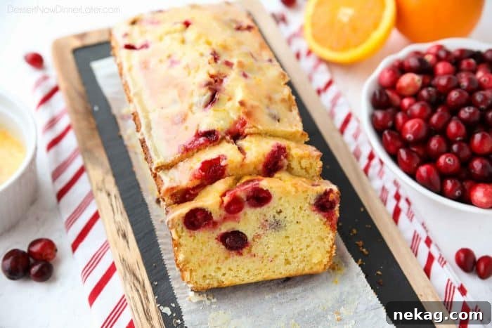 Cranberry Orange Bread is a wonderful treat for the holidays, with a sweet orange glaze on top and pops of tart cranberries throughout.