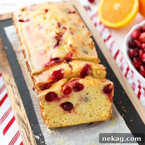 Cranberry Orange Bread is a wonderful treat for the holidays, with a sweet orange glaze on top and pops of tart cranberries throughout.