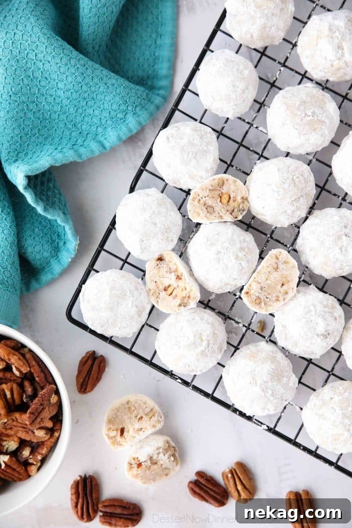 Snowball Cookies are round buttery shortbread cookies with chunks of pecans all rolled in powdered sugar. They melt in your mouth and are a delicious Christmas cookie.