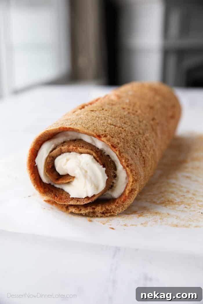 How to Make a Classic Carrot Cake Roll (Video Tutorial) 6 Cream cheese frosting rolled up inside of carrot cake.