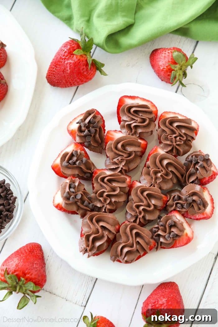 Plate of strawberries cut in half and topped with no bake chocolate cheesecake filling.