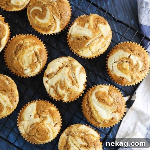 Pumpkin cream cheese muffins are light, fluffy, and moist, full of pumpkin spice flavor, and swirled with creamy cheesecake.
