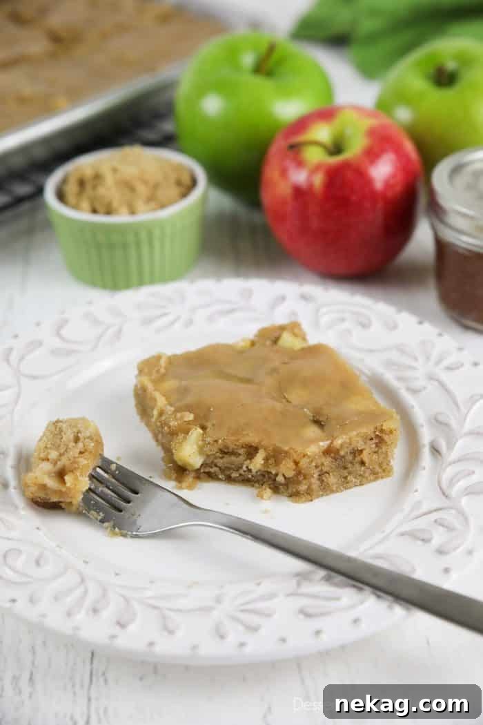Brown Sugar Glazed Apple Sheet Cake Recipe 2 Apple sheet cake made with fresh apples and a brown sugar glaze on top. A fork full on plate ready to eat.
