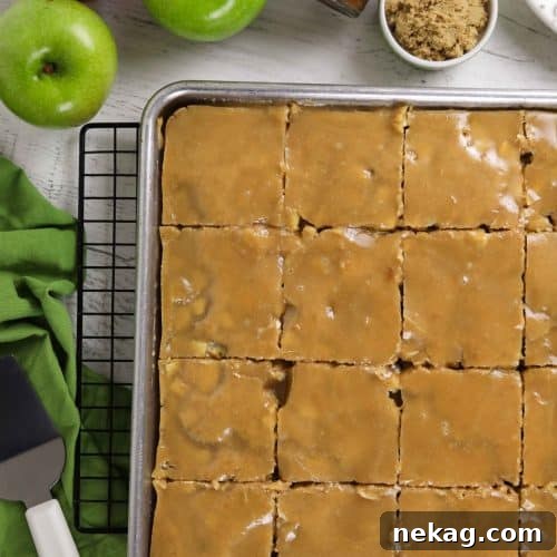 Brown Sugar Glazed Apple Sheet Cake Recipe 11 Glazed apple sheet cake in a pan cut into slices.