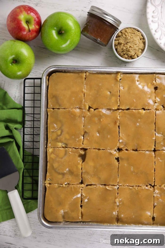 Brown Sugar Glazed Apple Sheet Cake Recipe 3 Glazed apple sheet cake in a pan cut into slices.