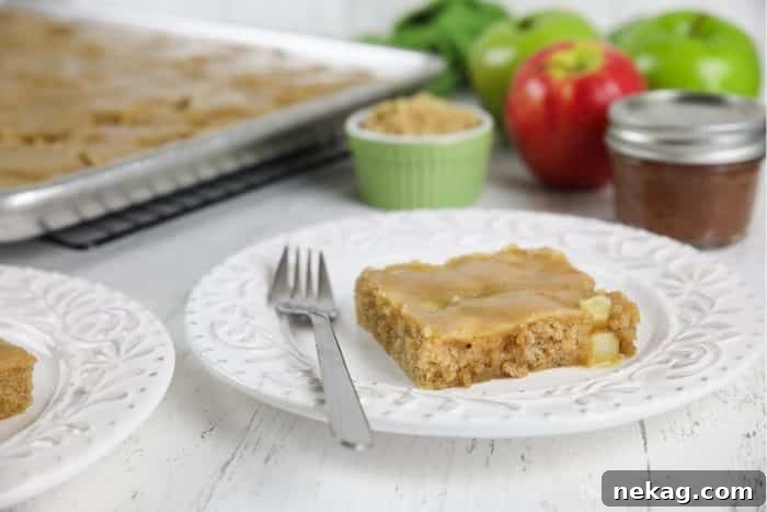 Brown Sugar Glazed Apple Sheet Cake Recipe 4 Slice of apple sheet cake on plate with fork.