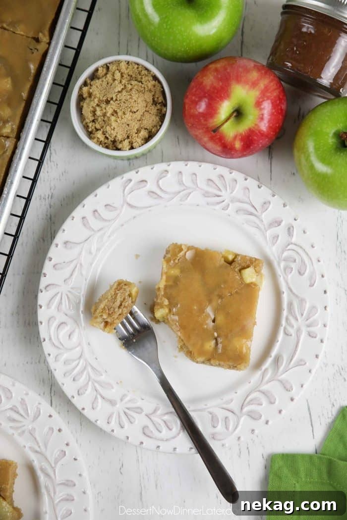 Brown Sugar Glazed Apple Sheet Cake Recipe 5 Slice of glazed apple sheet cake on a plate with a fork full of cake.