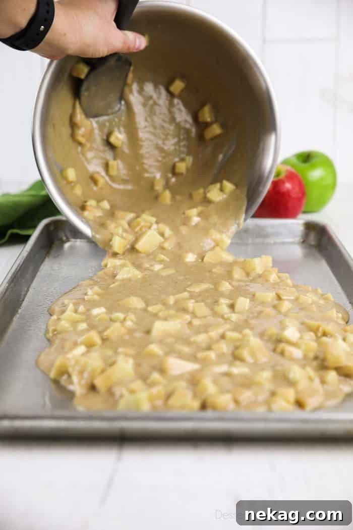 Brown Sugar Glazed Apple Sheet Cake Recipe 7 Apple cake batter being poured into sheet pan.