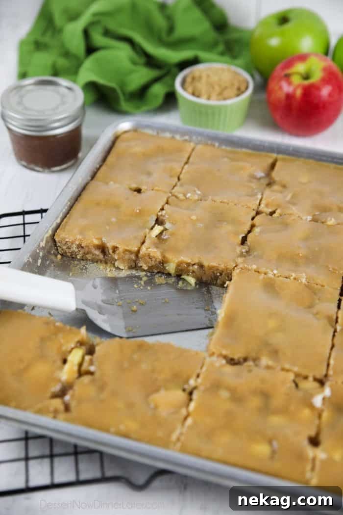 Brown Sugar Glazed Apple Sheet Cake Recipe 9 Apple sheet cake with brown sugar glaze in pan with a couple pieces missing.
