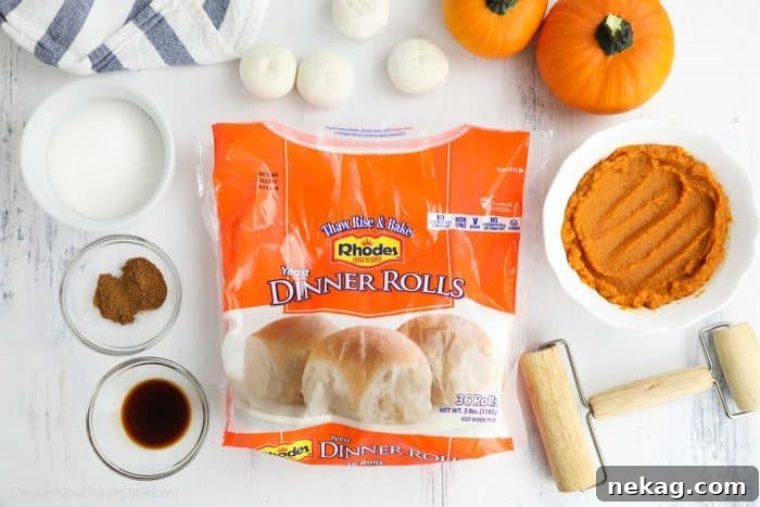 Pumpkin Spice Cinnamon Rolls with Cream Cheese Glaze 5 A bag of Rhodes Yeast Dinner Rolls surrounded by other ingredients in bowls, with a mini rolling pin on the side.