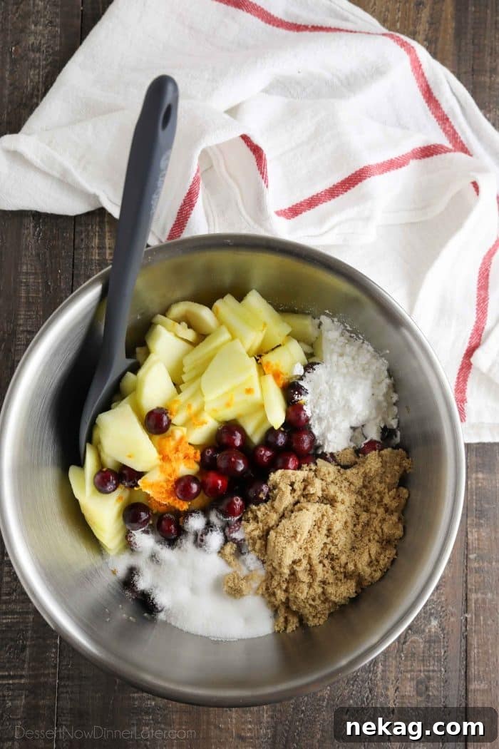 Cranberry Apple Pie Recipe: Tart-Sweet Holiday Dessert 6 Apple and cranberry pie filling ingredients in a bowl.