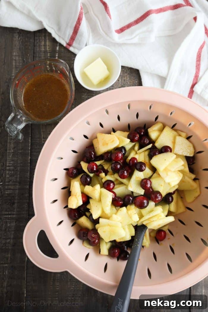 Cranberry Apple Pie Recipe: Tart-Sweet Holiday Dessert 7 Cranberry apple pie filling being strained with a colander.