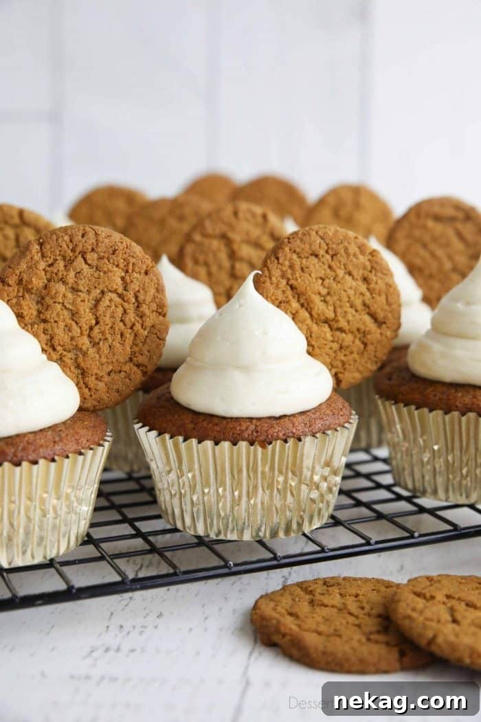 Gingerbread Cupcakes Recipe: Spiced Frosting and Holiday Tips 2 Gingerbread cupcakes with cream cheese frosting and a gingersnap cookies on top.