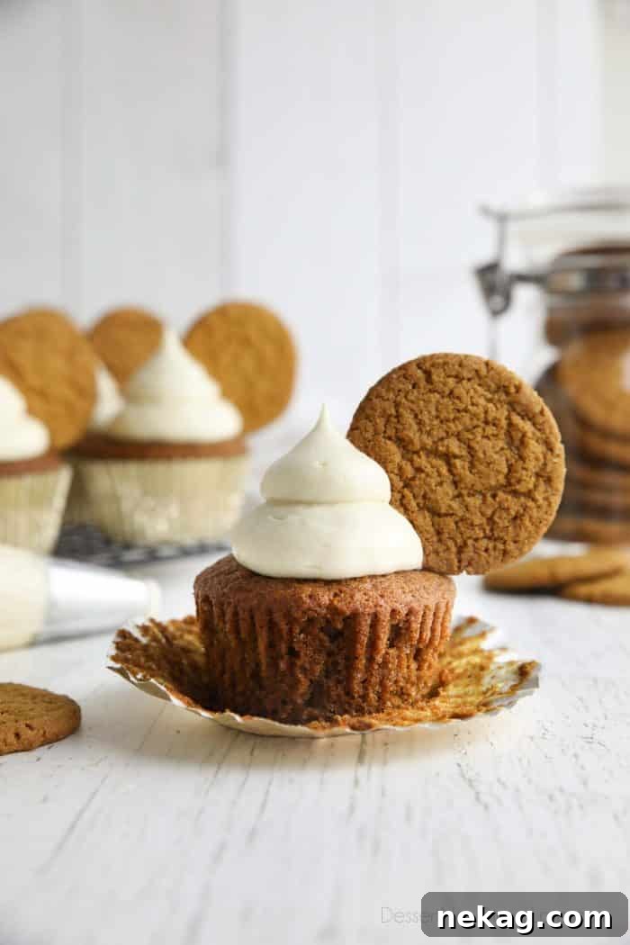 Gingerbread Cupcakes Recipe: Spiced Frosting and Holiday Tips 3 Spiced gingerbread cupcake with cream cheese frosting and a gingersnap cookie on top.