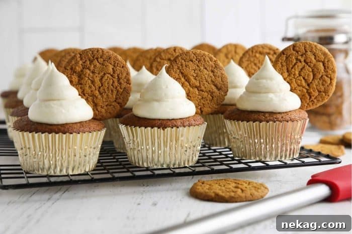 Gingerbread Cupcakes Recipe: Spiced Frosting and Holiday Tips 5 Gingerbread cupcakes with cream cheese frosting and a gingersnap cookies on top.