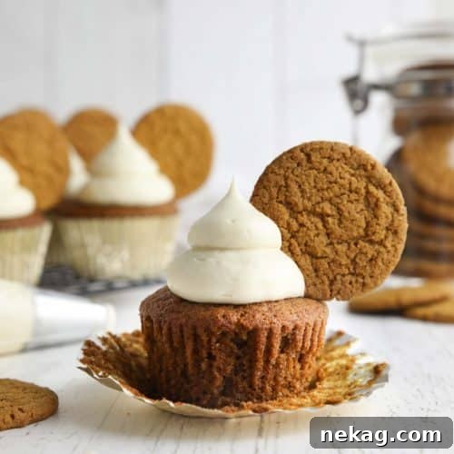 Gingerbread Cupcakes Recipe: Spiced Frosting and Holiday Tips 7 Spiced gingerbread cupcake with cream cheese frosting and a gingersnap cookie on top.