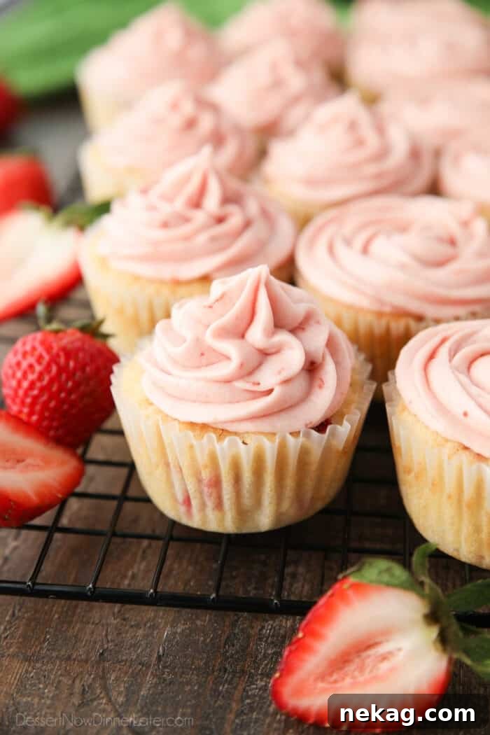 Fresh Strawberry Cupcakes with Real Fruit Frosting 4 Strawberry cupcakes with strawberry frosting piped on top.