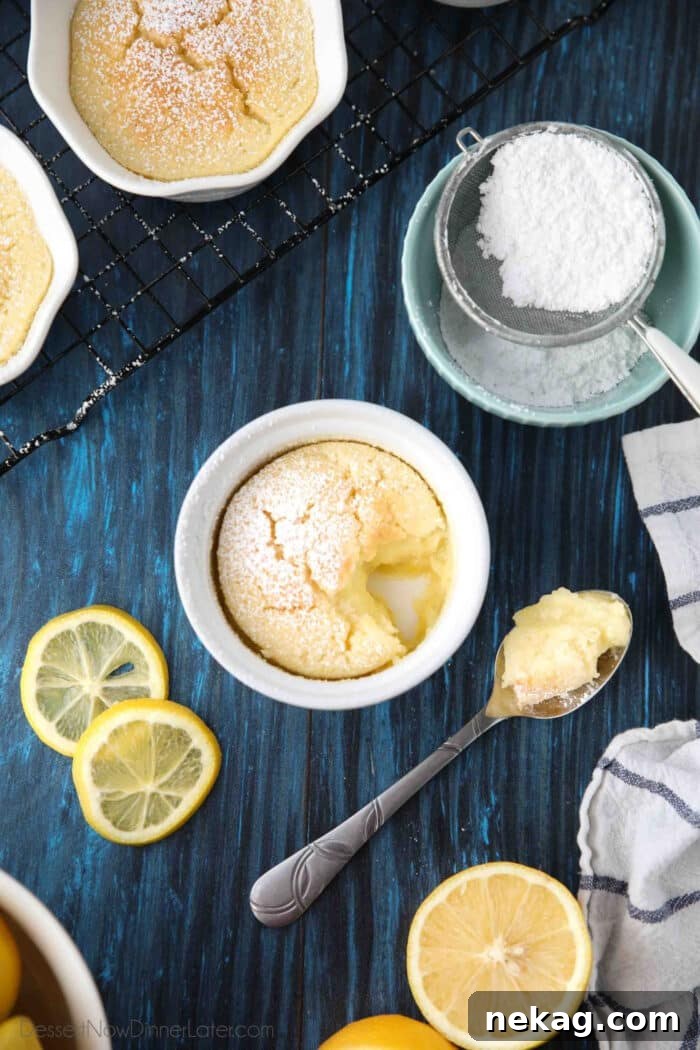 Light and Luscious Lemon Pudding Cake Recipe 3 Spoonful of lemon pudding cake next to ramekin with lemons and powdered sugar on the side.