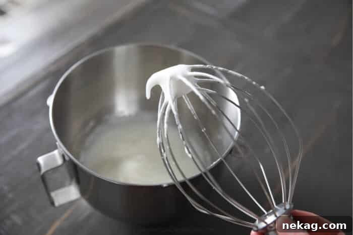 Light and Luscious Lemon Pudding Cake Recipe 4 Whisk demonstrating egg whites with soft peaks.