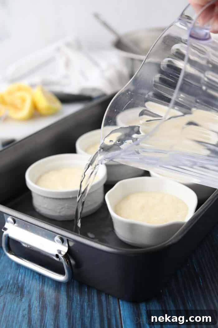 Light and Luscious Lemon Pudding Cake Recipe 6 Pouring water into roasting pan around lemon pudding cakes.