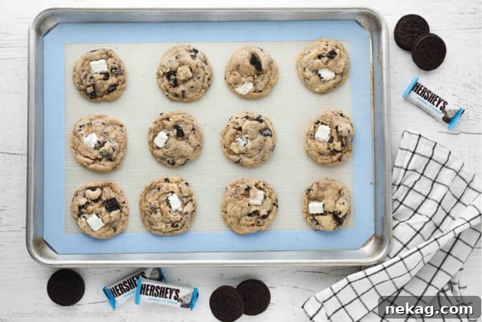 Cookies & Cream Sandwich Cookies: Homemade Oreo-Style Recipe 7 Cookie tray with baked cookies and cream cookies. Oreos and Hershey's Cookies 'n' Creme candy bars on the side.