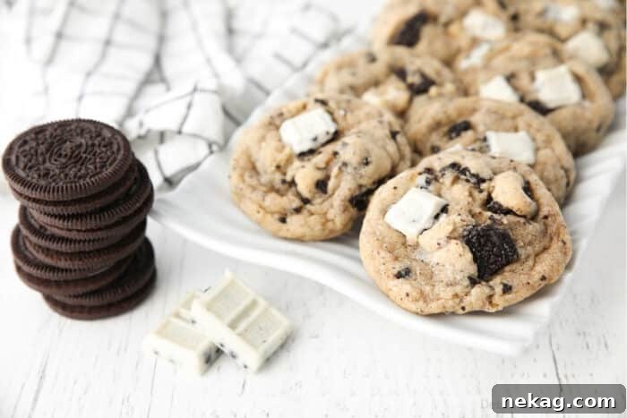 Cookies & Cream Sandwich Cookies: Homemade Oreo-Style Recipe 8 Plate of cookies and cream cookies with a stack of Oreos and a broken up cookie & cream candy bar on the side.