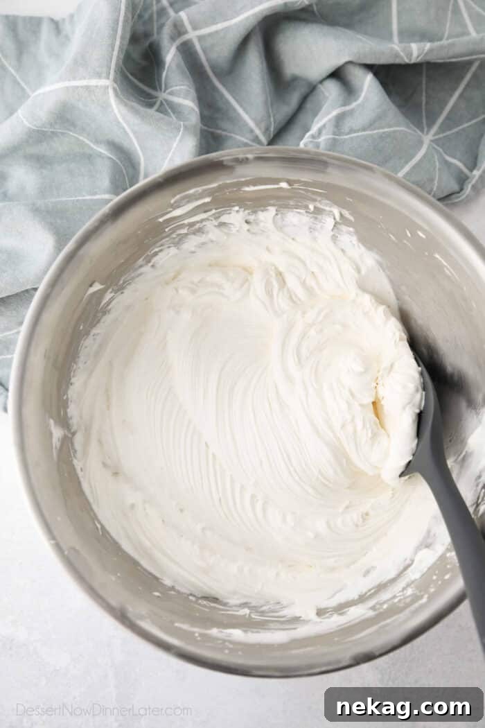 Whipped Cream Cheese Frosting Recipe (Video Tutorial) 4 Bowl with ripples of cream cheese whipped cream frosting.