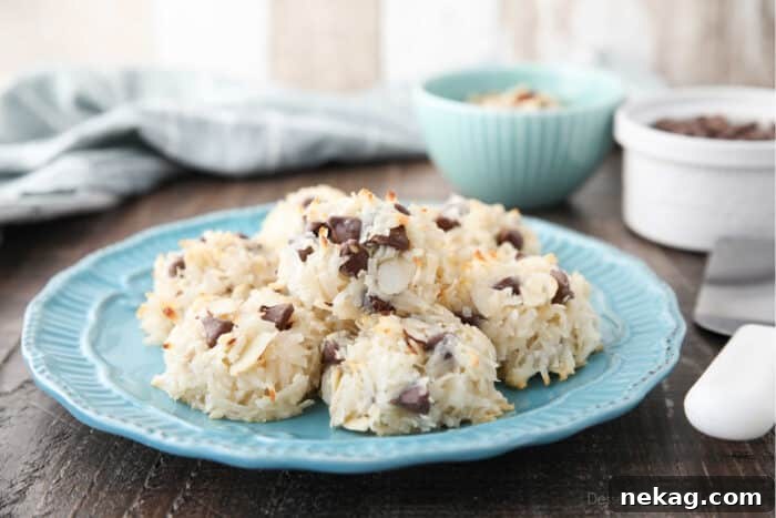 Almond Joy Cookie Recipe with Coconut, Almonds & Chocolate Chips 9 Side view of a plate of coconut macaroons with almonds and chocolate chips.