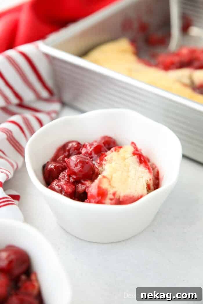 Classic Cherry Cobbler Recipe with Golden Biscuit Topping 3 Cherry Cobbler in a bowl made from cherry pie filling and homemade cake batter.