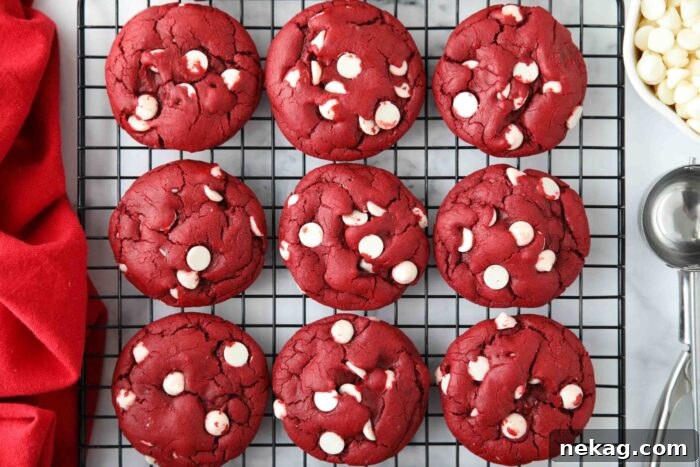 Red Velvet Cake Mix Cookies with white chocolate chips on a wire cooling rack.