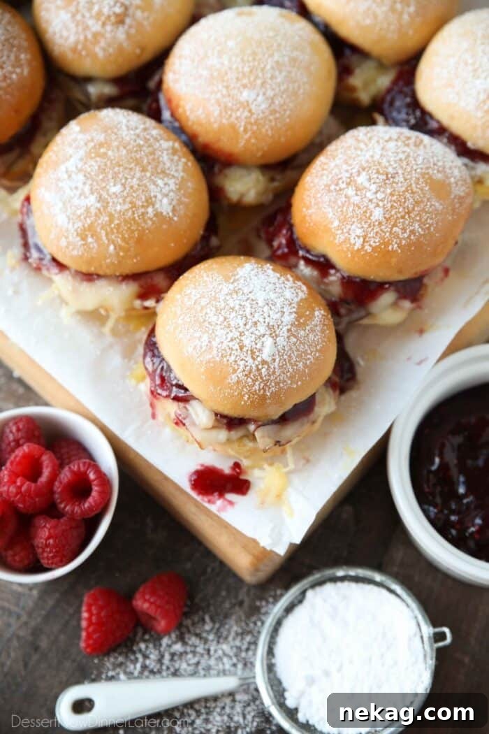 Crispy Monte Cristo Sliders with Ham, Turkey & Melty Cheese 3 Top view of Monte Cristo Sliders with jam oozing out.