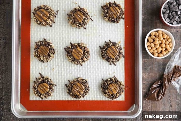Finished turtle thumbprint cookies on sheet tray.