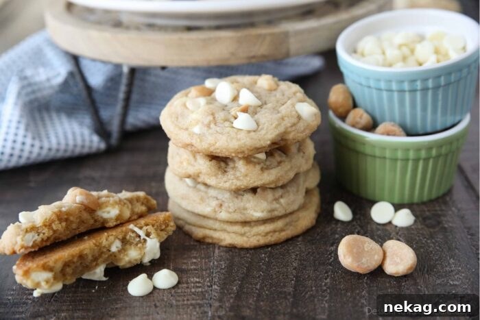 White Chocolate Macadamia Nut Cookie Recipe for Chewy Crispy Cookies 11 Stack of White Chocolate Macadamia Nut Cookies with one cookie broken in half to show the soft center with melted white chocolate chips.