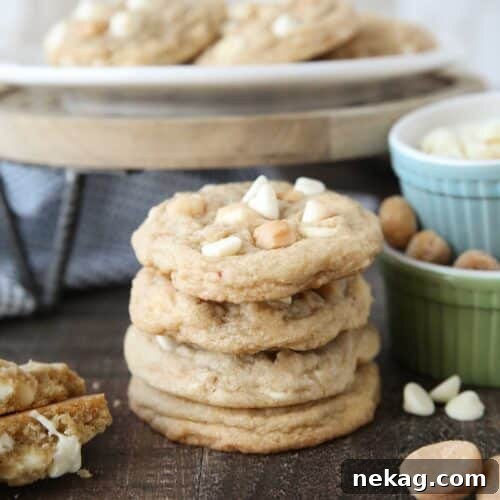 White Chocolate Macadamia Nut Cookie Recipe for Chewy Crispy Cookies 12 Stacked White Chocolate Macadamia Nut Cookies with extra nuts and white chocolate chips on the side.