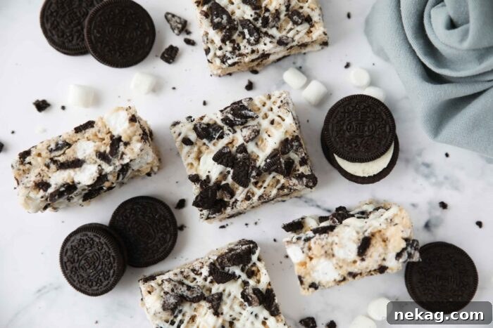 Oreo Rice Krispie Treats Recipe: Chewy Chocolate Marshmallow Squares 9 Rice krispie treats with white chocolate drizzle and Oreo chunks.
