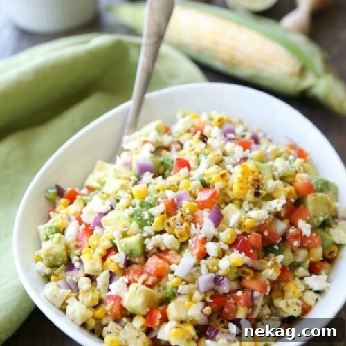 Corn Salad with Queso Fresco is loaded with grilled corn, crisp onions and peppers, and creamy avocado, all topped with a homemade cilantro lime vinaigrette and generous helping of delicious queso fresco. A great side dish for your summer barbecue.