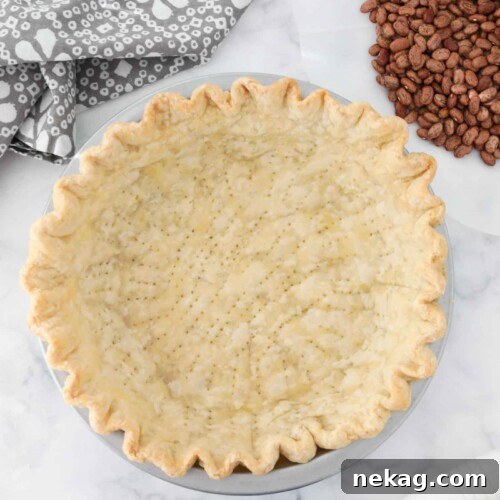 Blind baked pie crust in pan ready for filling.