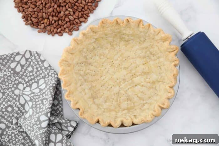 Top view of blind baked pie crust in pan.