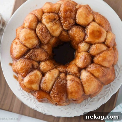 Soft Pull-Apart Monkey Bread Recipe with Video Tutorial 12 Top view of sticky warm monkey bread on a plate.