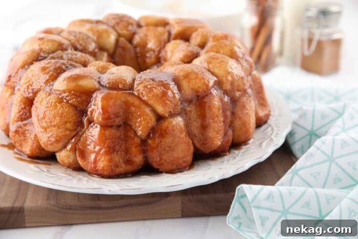 Soft Pull-Apart Monkey Bread Recipe with Video Tutorial 10 Side view of caramelized monkey bread on a plate.