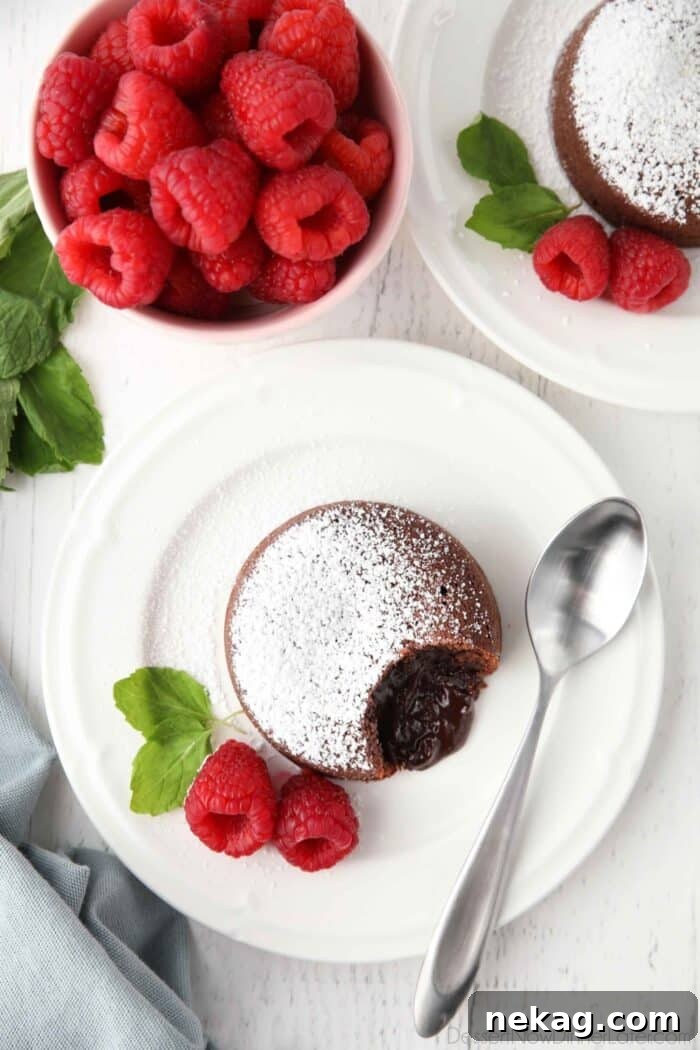 Molten Chocolate Lava Cake Recipe with Step-by-Step Video 3 Top view of lava cake on plate with soft chocolate center.
