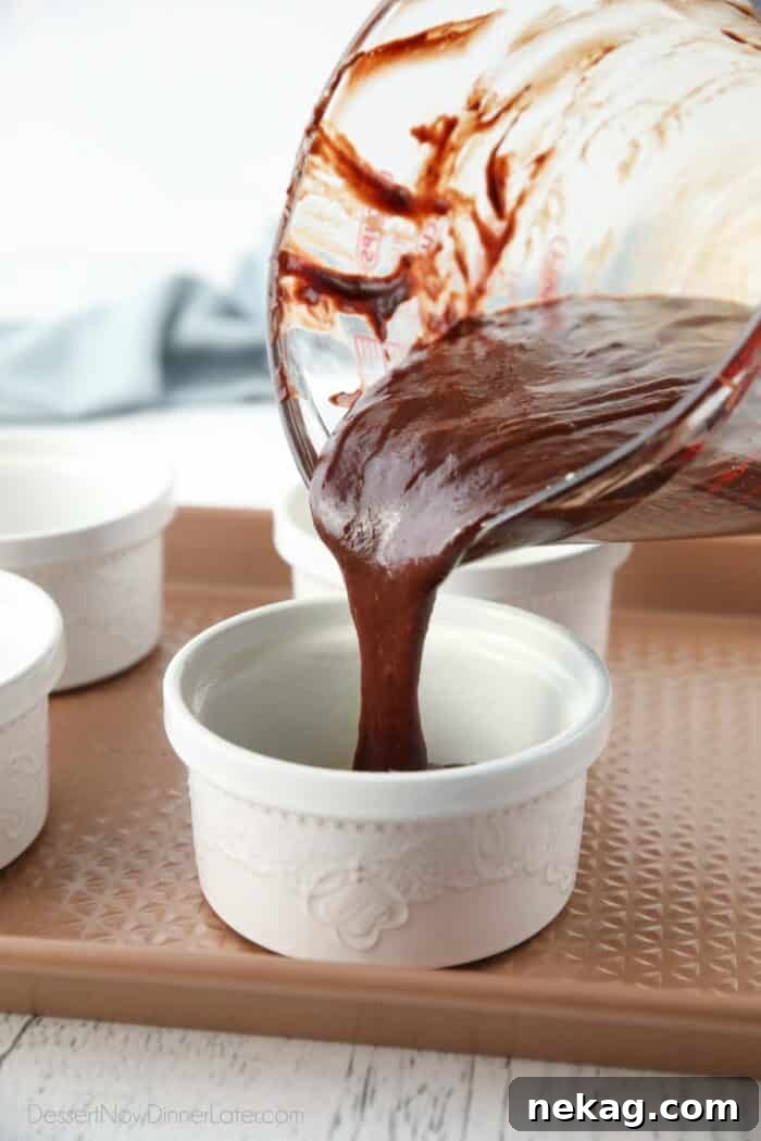 Molten Chocolate Lava Cake Recipe with Step-by-Step Video 7 Pouring chocolate cake batter into ramekins.