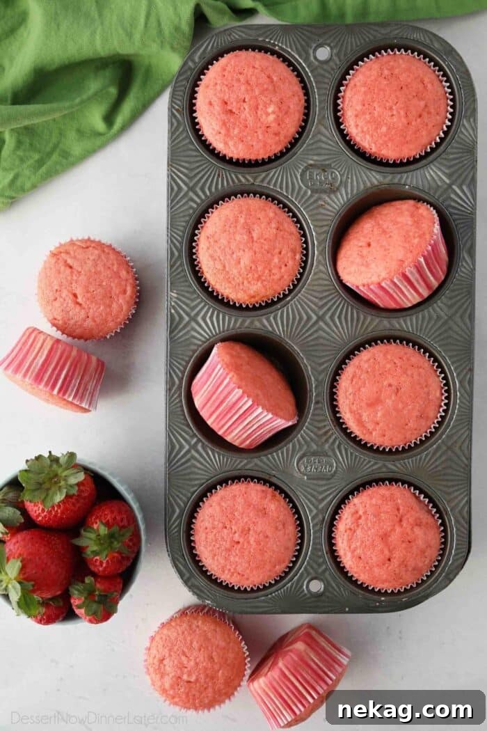 Strawberry Cupcakes Recipe with Step-by-Step Video Tutorial 4 Strawberry Cupcakes in a muffin pan.