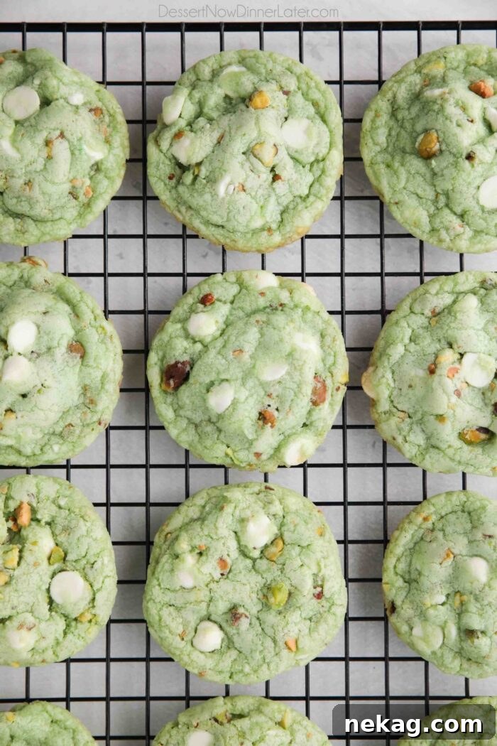 Baked pistachio pudding cookies on a wire cooling rack.