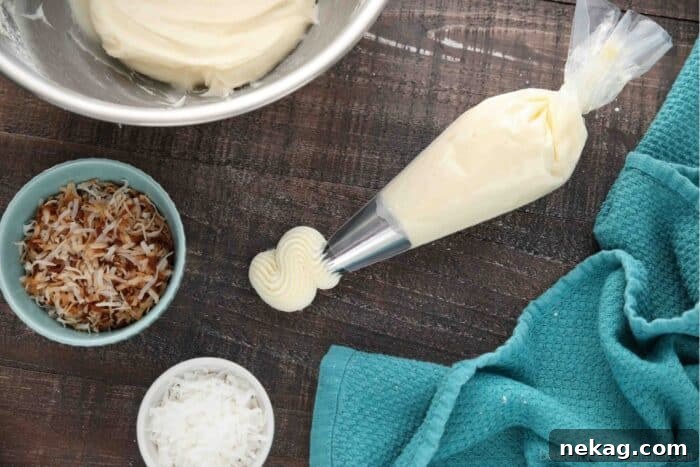 Piping bag with frosting coming out and two bowls of toasted coconut and sweetened coconut flakes.