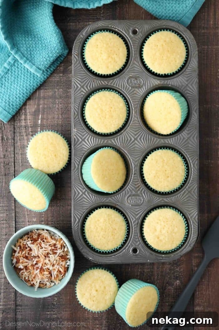 Moist Coconut Cupcakes with Creamy Coconut Frosting 4 Top view of coconut cupcakes in a tin pan.